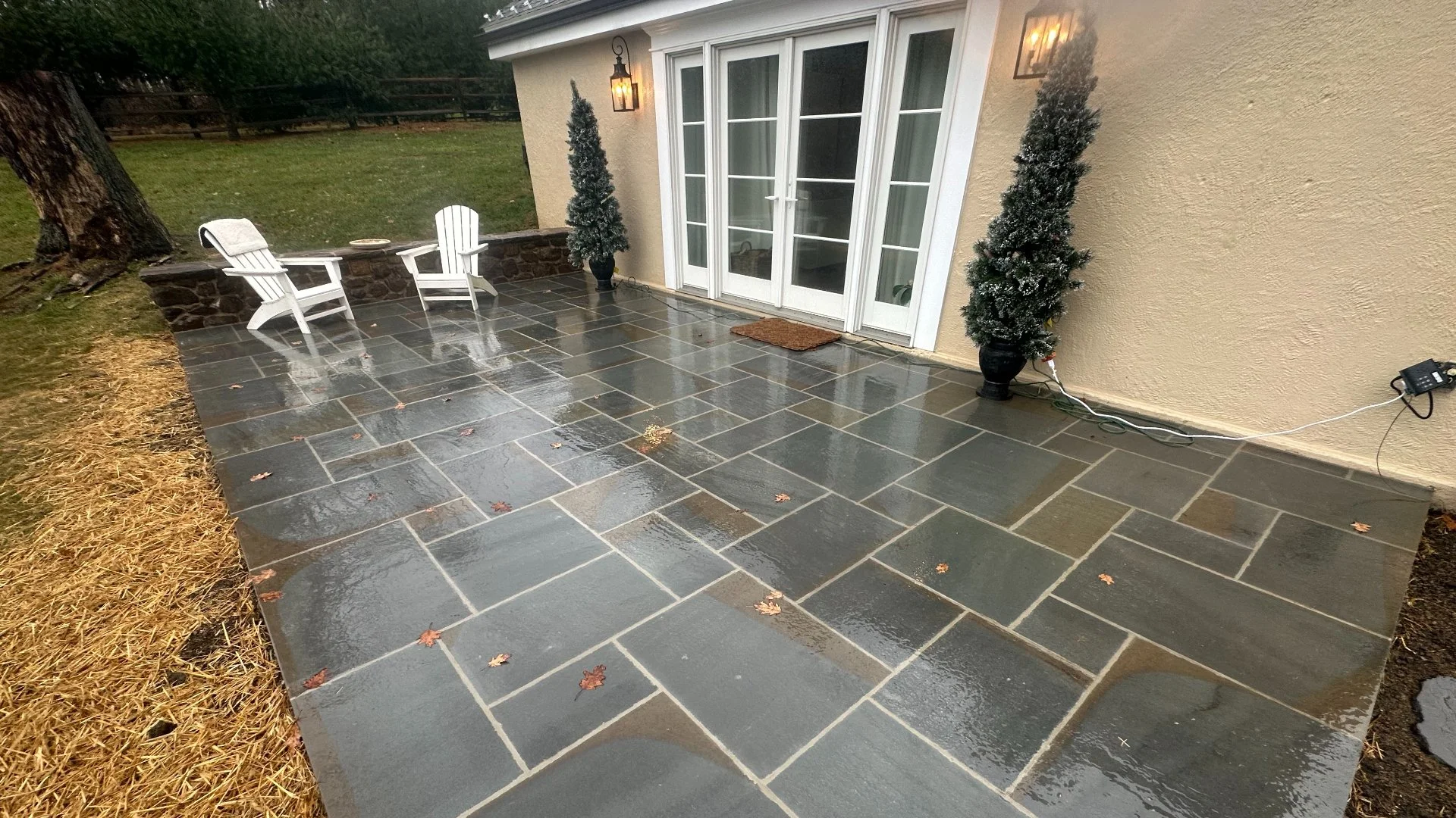 Stone patio area with chairs and greenery in West Chester, PA.