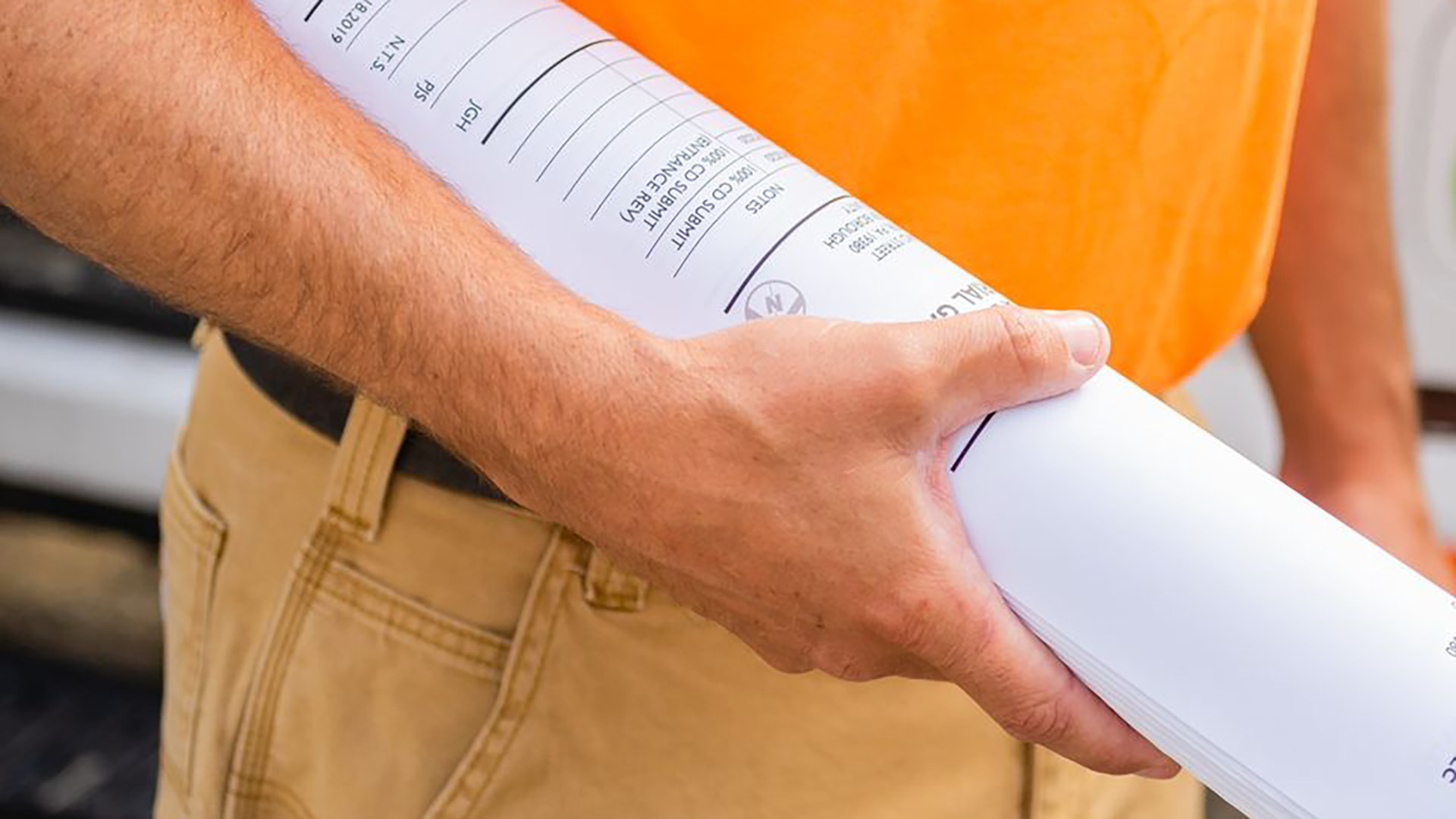 A closeup of our landscaper holding blueprints in Downingtown, PA.