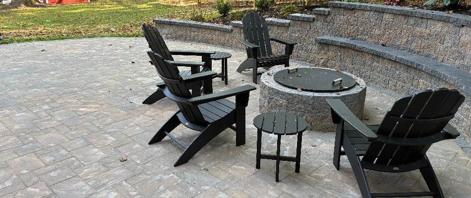 Chairs around a fire pit in West Chester, PA, next to a retaining wall.