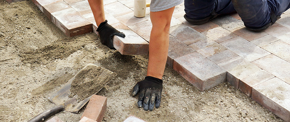 Our landscaper installing concrete pavers on a property in West Chester, PA.