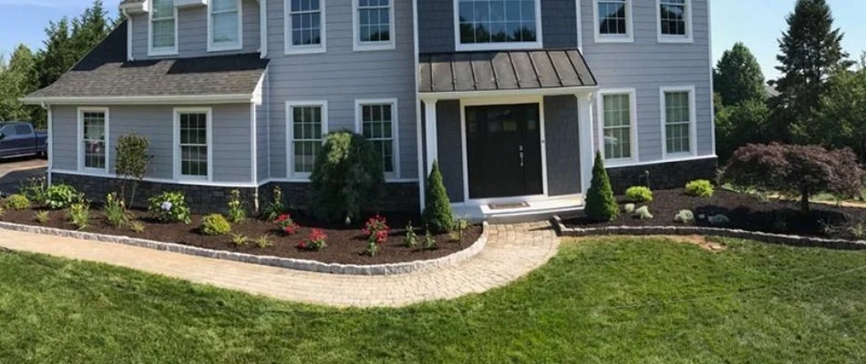Landscape bed in West Chester, PA, with mulch along a walkway.