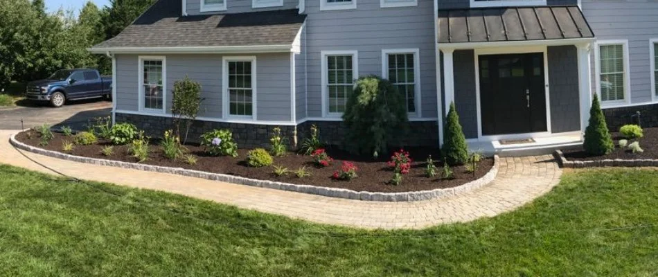 Landscape bed in West Chester, PA, with mulch, flowers, and shrubs.