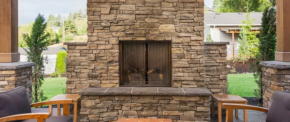 Outdoor fireplace in West Chester, PA, with a fire screen.