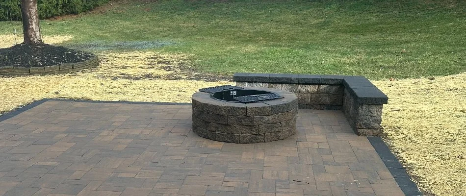 Patio in West Chester, PA, with fire pit and seating wall.