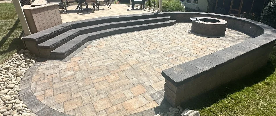 Paver patio in West Chester, PA, with retaining wall and fire pit.