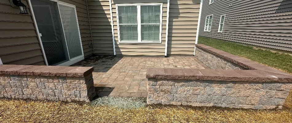 Seating wall around a backyard paver patio in West Chester, PA.