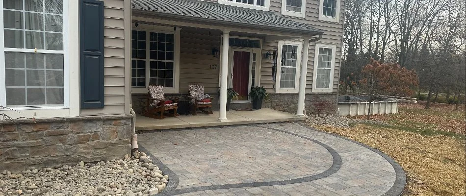 Inviting front porch with stone accents and paver walkway in West Chester, PA.