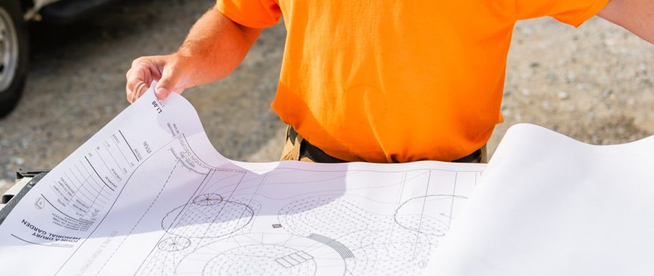 Our landscaper looking through blueprints for a job in Exton, PA.