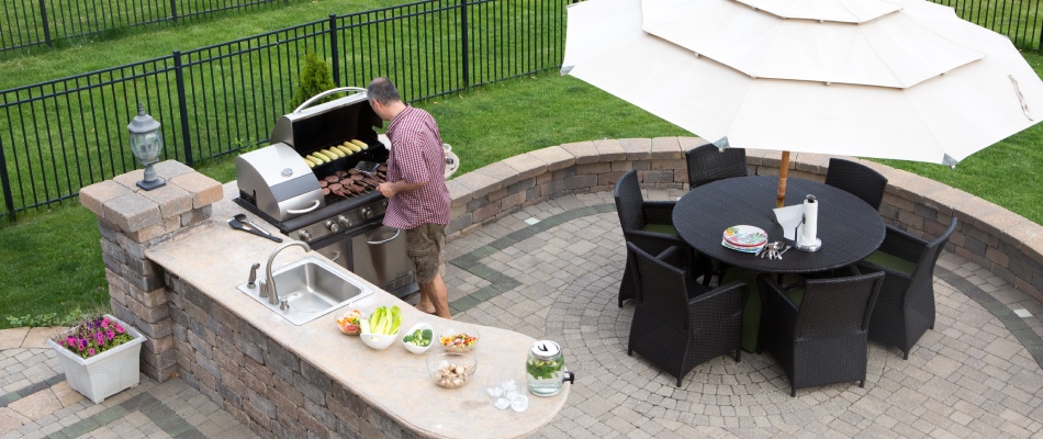 Home owner grilling on outdoor kitchen appliance in Downingtown, PA.