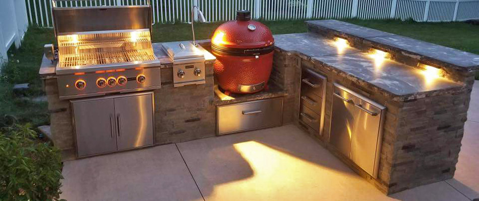 A night shot of a stone outdoor kitchen in Chester Springs, PA.