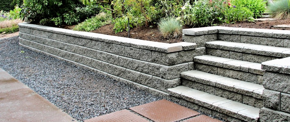 Stone retaining wall with outdoor steps installed in Malvern, PA.